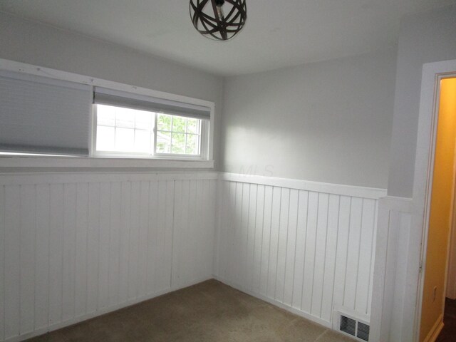 112 N Cherry St, Mount Gilead, OH 43338 - carpeted empty room with wainscoting