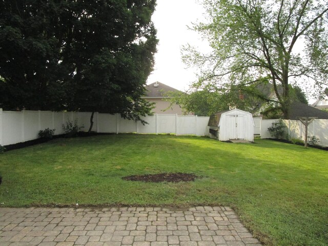 112 N Cherry St, Mount Gilead, OH 43338 - fenced backyard featuring a storage shed and a patio area