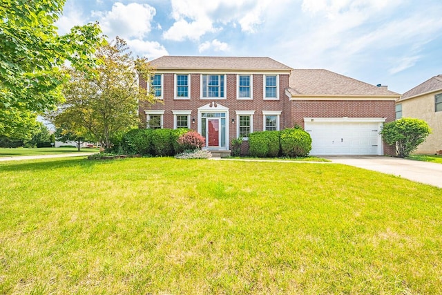 8510 Morgan St, Pickerington, OH 43147 - colonial-style house featuring concrete driveway, an attached garage, a front yard, and brick siding