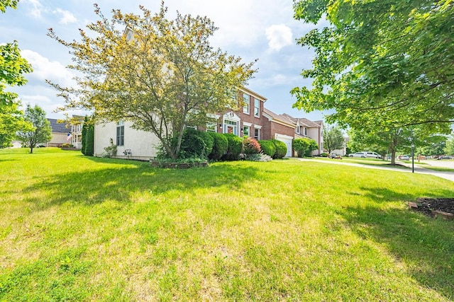 8510 Morgan St, Pickerington, OH 43147 - view of green lawn featuring an attached garage and driveway