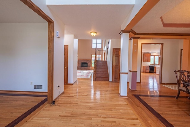 8510 Morgan St, Pickerington, OH 43147 - corridor featuring light wood-type flooring, stairs, plenty of natural light, and ornamental molding