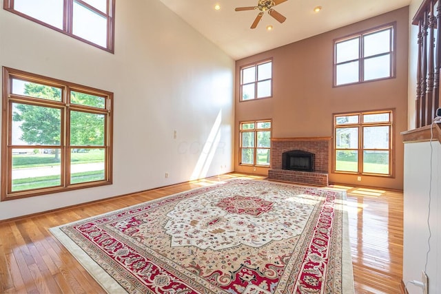 8510 Morgan St, Pickerington, OH 43147 - living area featuring a towering ceiling, a ceiling fan, hardwood / wood-style floors, a fireplace, and recessed lighting