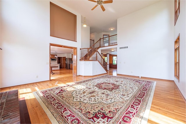 8510 Morgan St, Pickerington, OH 43147 - foyer entrance featuring a towering ceiling, stairs, ceiling fan, and wood finished floors