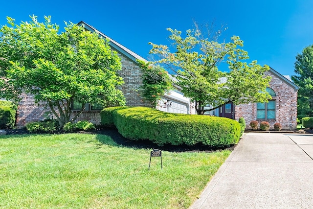 5608 Lynx Dr, Westerville, OH 43081 - view of property hidden behind natural elements with brick siding and a front lawn