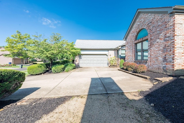 5608 Lynx Dr, Westerville, OH 43081 - view of front facade with concrete driveway, brick siding, and an attached garage