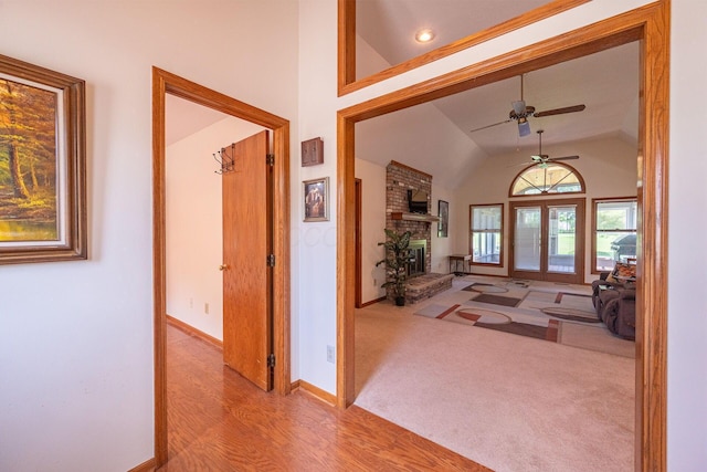 5608 Lynx Dr, Westerville, OH 43081 - foyer featuring lofted ceiling, a ceiling fan, wood finished floors, and a brick fireplace