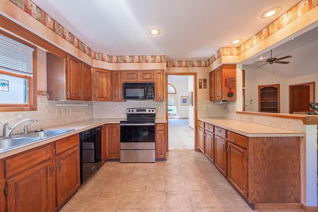 5608 Lynx Dr, Westerville, OH 43081 - kitchen with black appliances, brown cabinets, light countertops, a ceiling fan, and vaulted ceiling