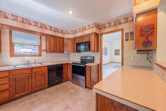 5608 Lynx Dr, Westerville, OH 43081 - kitchen featuring black appliances, brown cabinetry, light countertops, tasteful backsplash, and light flooring