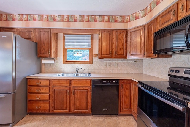 5608 Lynx Dr, Westerville, OH 43081 - kitchen featuring black appliances, light countertops, brown cabinets, and decorative backsplash
