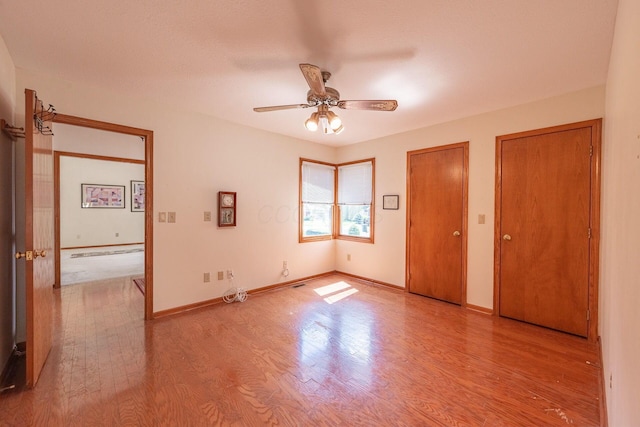 5608 Lynx Dr, Westerville, OH 43081 - unfurnished bedroom featuring wood finished floors, multiple closets, and a ceiling fan
