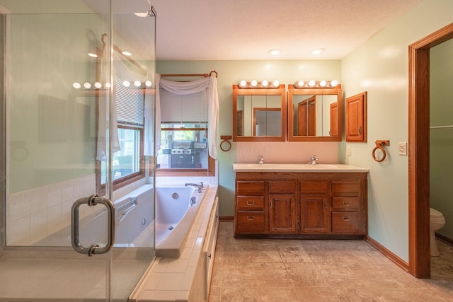 5608 Lynx Dr, Westerville, OH 43081 - bathroom with double vanity, a garden tub, a stall shower, and a textured ceiling