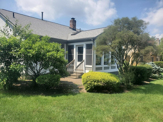 5608 Lynx Dr, Westerville, OH 43081 - back of house with entry steps, a shingled roof, a yard, and a chimney