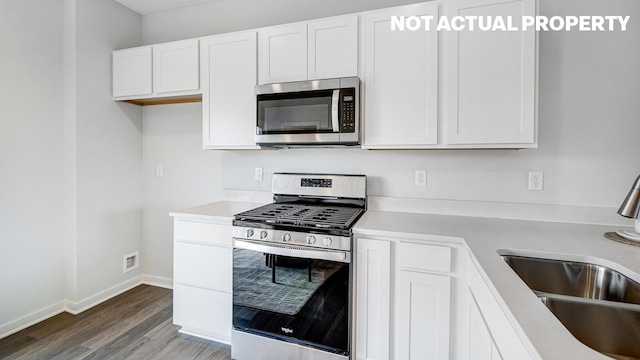 1415 Gimbles Dr, Columbus, OH 43223 - kitchen featuring stainless steel appliances, wood finished floors, light countertops, and white cabinets