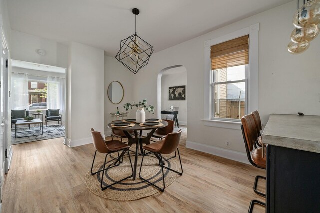 442 Thurman Ave, Columbus, OH 43206 - dining room with arched walkways and light wood-style floors