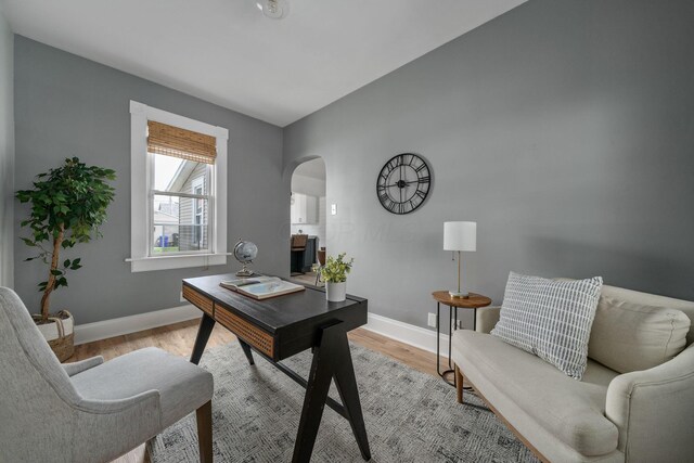442 Thurman Ave, Columbus, OH 43206 - home office with arched walkways and light wood-style flooring