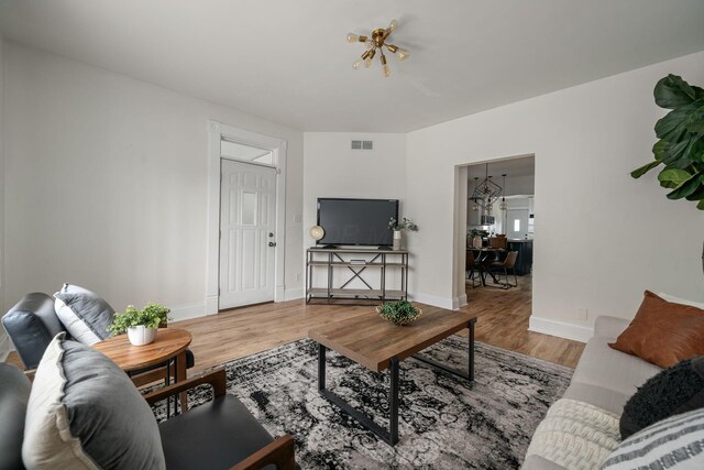 442 Thurman Ave, Columbus, OH 43206 - living room featuring wood finished floors and a chandelier