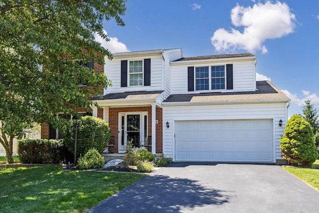 1626 Geranium Dr, Lewis Center, OH 43035 - traditional-style house with asphalt driveway, a garage, a front lawn, and brick siding