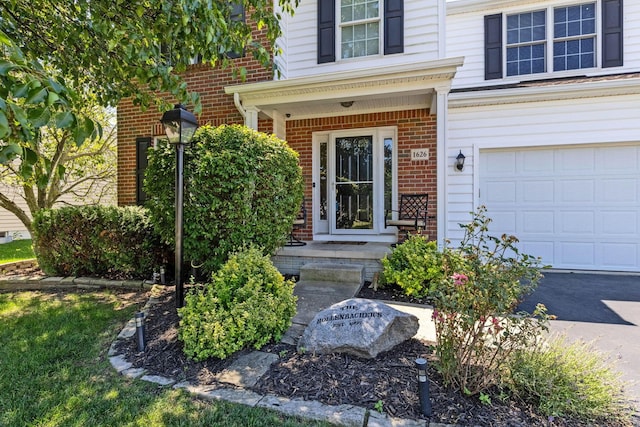 1626 Geranium Dr, Lewis Center, OH 43035 - view of exterior entry with brick siding and an attached garage