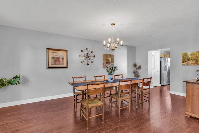 1626 Geranium Dr, Lewis Center, OH 43035 - dining space with wood finished floors, a chandelier, and a textured ceiling