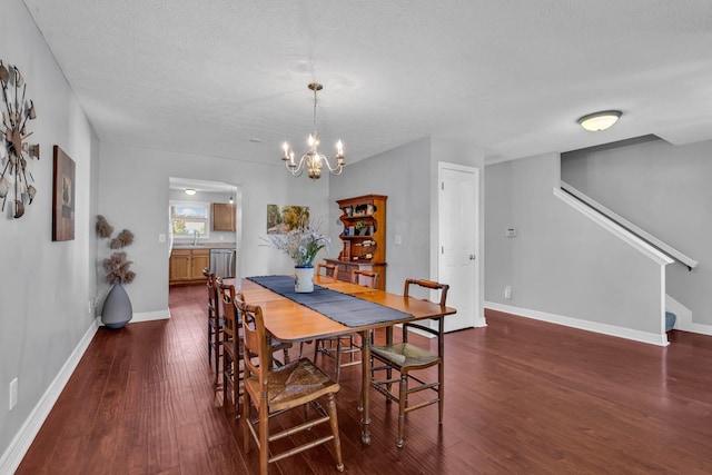 1626 Geranium Dr, Lewis Center, OH 43035 - dining room with dark wood finished floors, a chandelier, stairway, and a textured ceiling
