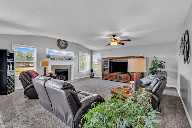 1626 Geranium Dr, Lewis Center, OH 43035 - carpeted living room with a ceiling fan, a tile fireplace, vaulted ceiling, and a textured ceiling