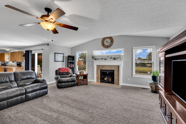 1626 Geranium Dr, Lewis Center, OH 43035 - living area with a tile fireplace, lofted ceiling, carpet flooring, and a ceiling fan