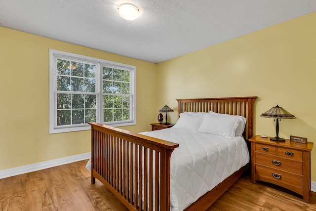 1626 Geranium Dr, Lewis Center, OH 43035 - bedroom featuring wood finished floors and a textured ceiling