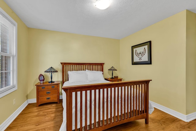 1626 Geranium Dr, Lewis Center, OH 43035 - bedroom featuring wood finished floors and a textured ceiling