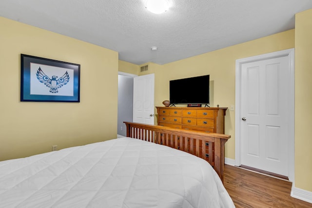 1626 Geranium Dr, Lewis Center, OH 43035 - bedroom featuring wood finished floors and a textured ceiling