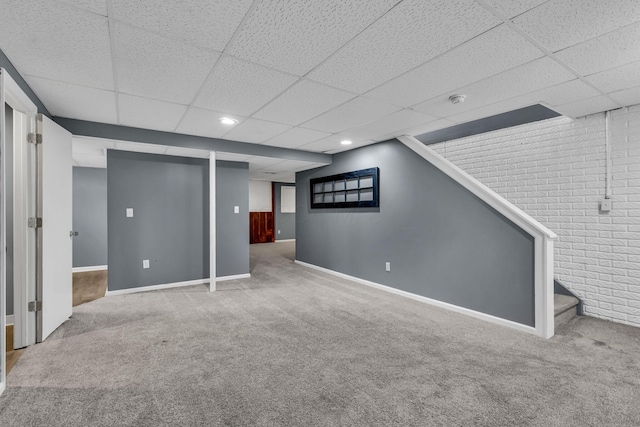 1626 Geranium Dr, Lewis Center, OH 43035 - finished below grade area with carpet, a paneled ceiling, stairs, and brick wall