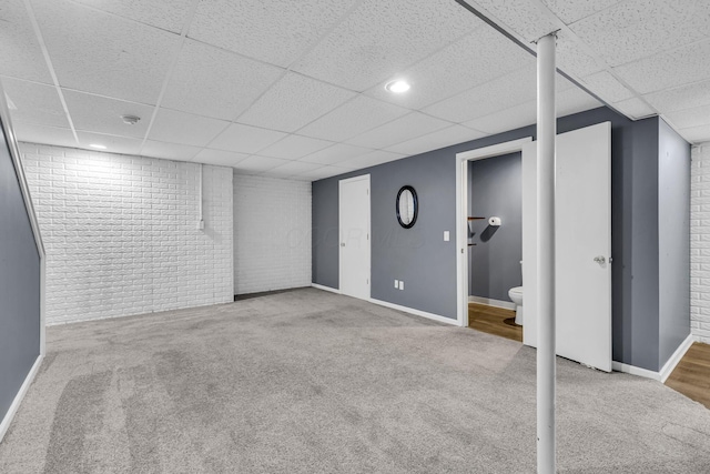 1626 Geranium Dr, Lewis Center, OH 43035 - finished basement with a paneled ceiling, brick wall, and carpet flooring