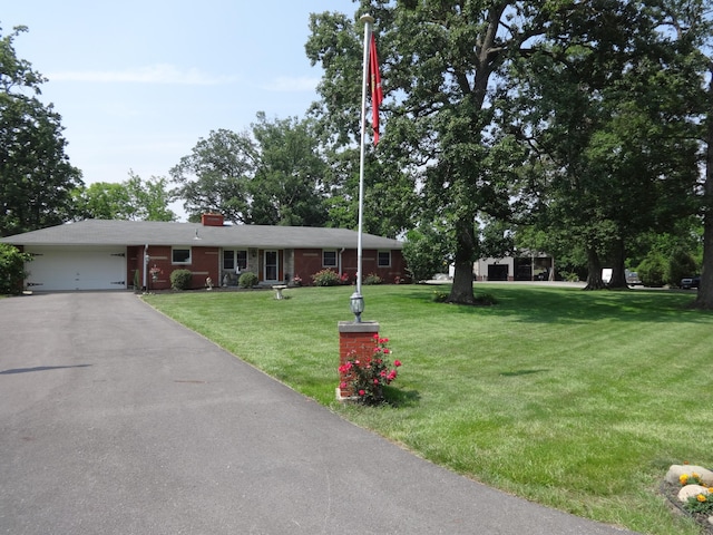 1766 Thrailkill Rd, Grove City, OH 43123 - ranch-style house featuring an attached garage, a front yard, asphalt driveway, a chimney, and brick siding