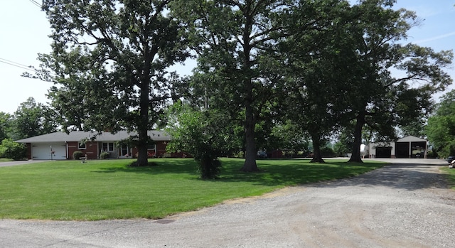 1766 Thrailkill Rd, Grove City, OH 43123 - view of front facade with a front yard, driveway, and a detached garage