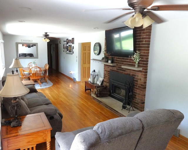 1766 Thrailkill Rd, Grove City, OH 43123 - living room with a ceiling fan, wood finished floors, and a brick fireplace
