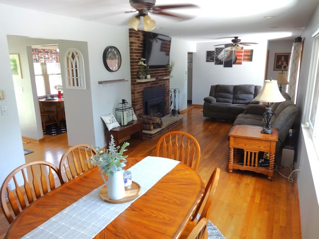 1766 Thrailkill Rd, Grove City, OH 43123 - dining area with ceiling fan, wood finished floors, and a fireplace
