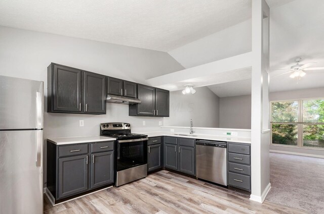 5727 Sundial Dr, Galloway, OH 43119 - kitchen with appliances with stainless steel finishes, under cabinet range hood, light countertops, ceiling fan, and vaulted ceiling