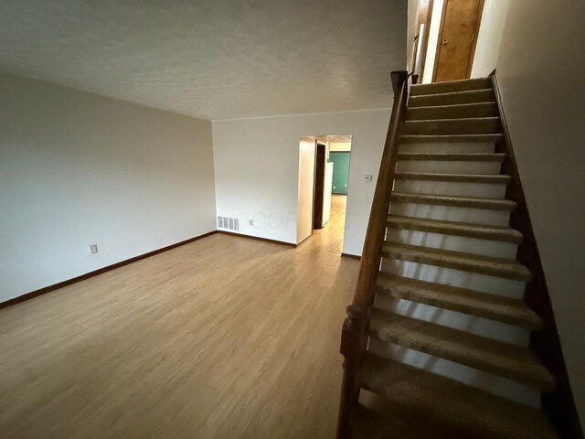 5600 Cartwright Ln Unit 19, Columbus, OH 43231 - staircase with wood finished floors and baseboards