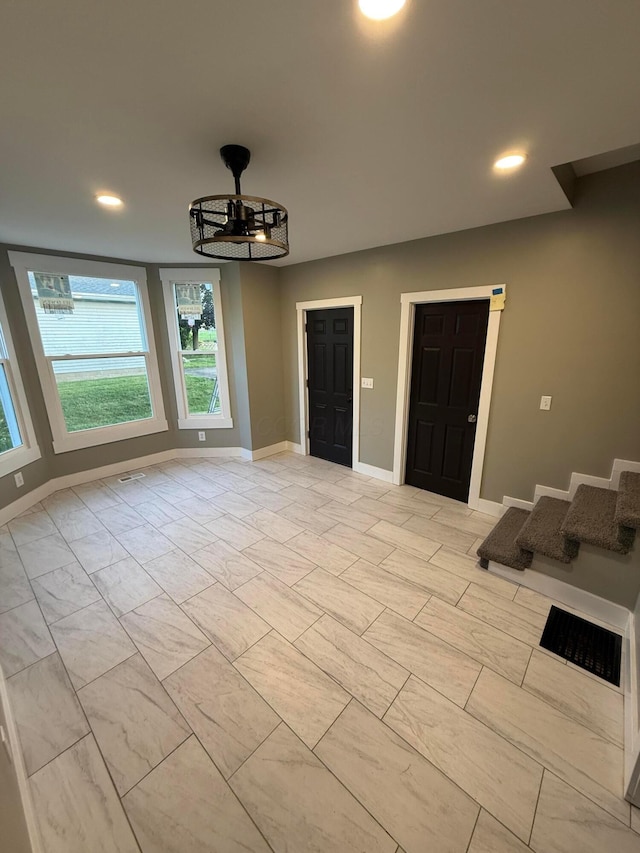274 Woods Ave, Newark, OH 43055 - unfurnished room featuring recessed lighting, stairs, and light marble finish floors