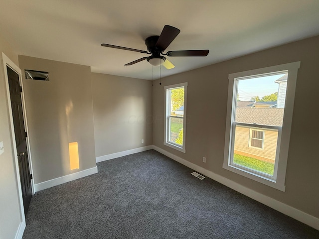 274 Woods Ave, Newark, OH 43055 - empty room featuring dark colored carpet and a ceiling fan