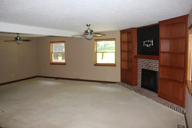 6781 Thoreau Ln NE, Baltimore, OH 43105 - unfurnished living room with ceiling fan, a brick fireplace, light carpet, and a textured ceiling
