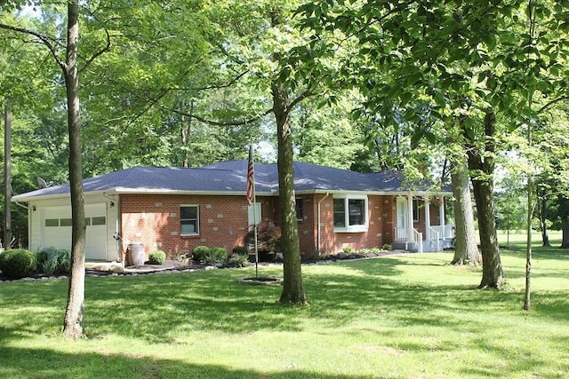 6781 Thoreau Ln NE, Baltimore, OH 43105 - ranch-style home with a garage, brick siding, a front yard, and covered porch