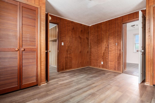 1680 Linwood Ave, Columbus, OH 43207 - unfurnished room featuring wood finished floors, wooden walls, and a textured ceiling