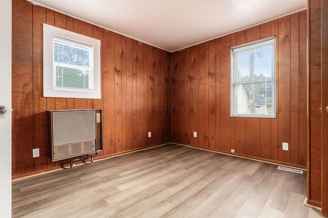 1680 Linwood Ave, Columbus, OH 43207 - unfurnished room with heating unit, wood finished floors, and wood walls