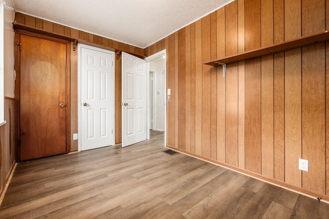 1680 Linwood Ave, Columbus, OH 43207 - unfurnished bedroom with wooden walls and wood finished floors