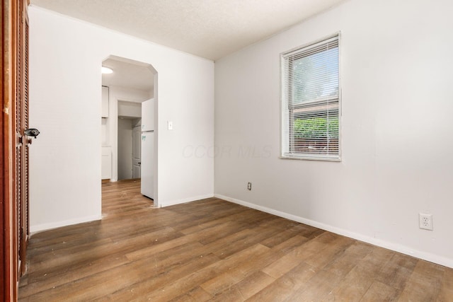 1680 Linwood Ave, Columbus, OH 43207 - spare room featuring arched walkways and wood finished floors