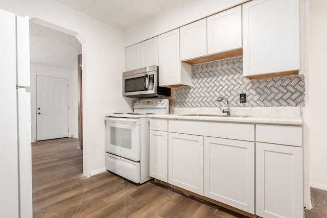 1680 Linwood Ave, Columbus, OH 43207 - kitchen with white appliances, backsplash, white cabinets, and light countertops