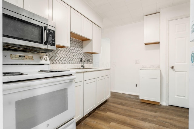 1680 Linwood Ave, Columbus, OH 43207 - kitchen featuring electric stove, stainless steel microwave, dark wood-style floors, backsplash, and light countertops