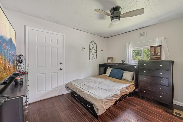 15586 Stump Run, Laurelville, OH 43135 - bedroom with dark wood-style flooring, a ceiling fan, and a textured ceiling