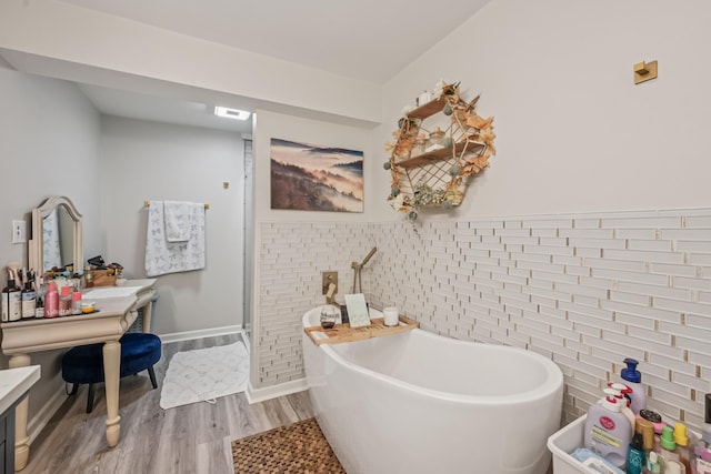 15586 Stump Run, Laurelville, OH 43135 - full bath with tile walls, wood finished floors, a freestanding tub, and vanity