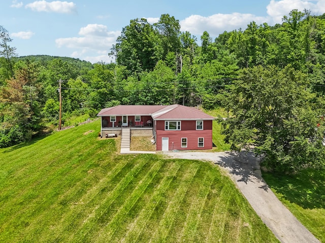 15586 Stump Run, Laurelville, OH 43135 - view of front of house with a view of trees, a front yard, and a metal roof